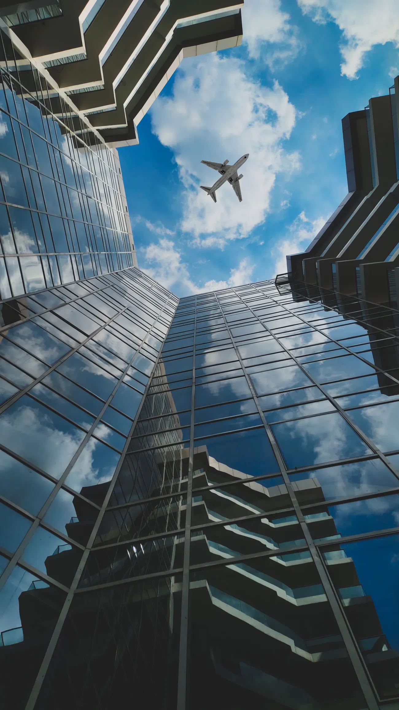 Aircraft flying over corporate glass towers — official and delegation travel