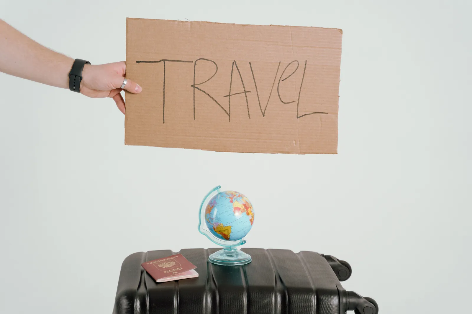 Travel essentials — passport, globe and suitcase ready for a work trip