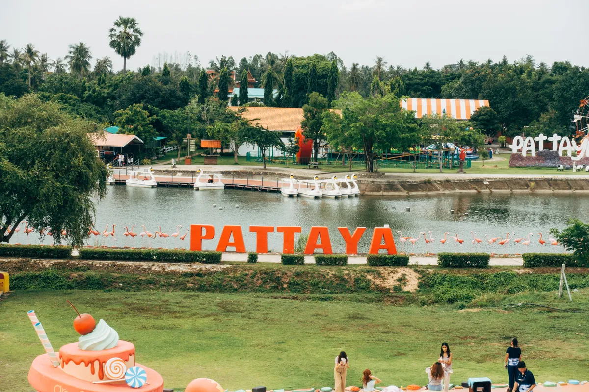 The Pattaya sign with flamingos beside a lake in a park in Pattaya, Thailand